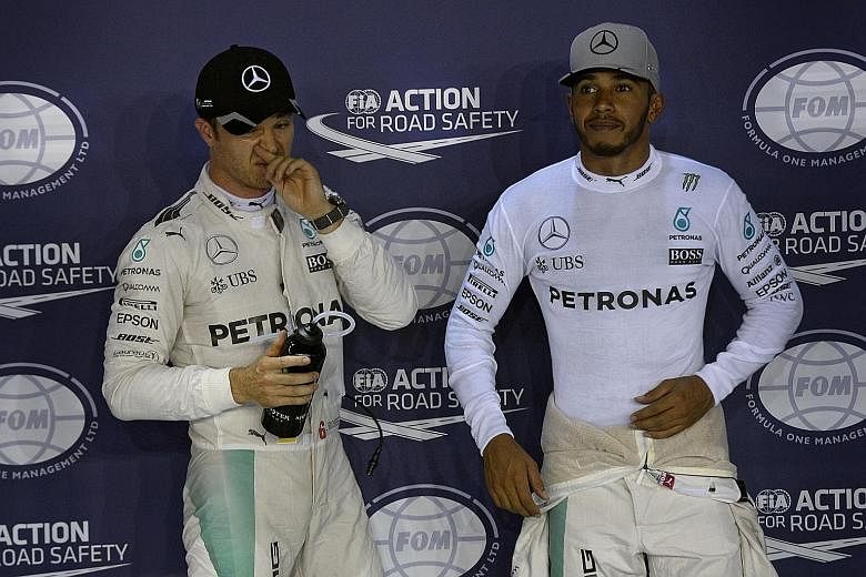 Mercedes F1 drivers Nico Rosberg and Lewis Hamilton after qualifying at the 2016 Singapore Grand Prix. The German retired at the end of that season after winning his sole drivers' title.