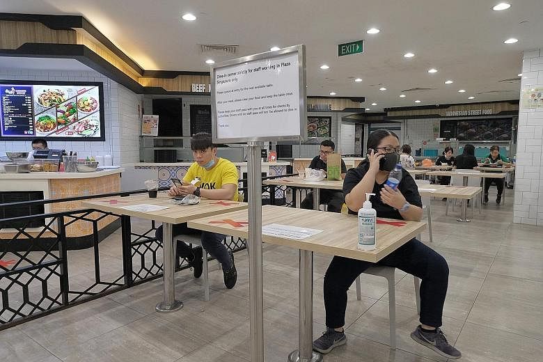 An eating area for Plaza Singapura staff at Kopitiam foodcourt on Tuesday. CapitaLand, which operates 18 malls including Plaza Singapura, said food delivery riders can eat at designated areas while observing safe distancing.