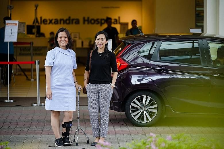 Alexandra Hospital's patient service associate Jaylyn Ong (left) and medical laboratory technologist Candy Austria Quiambao are among healthcare workers who have benefited from the GrabCare service.