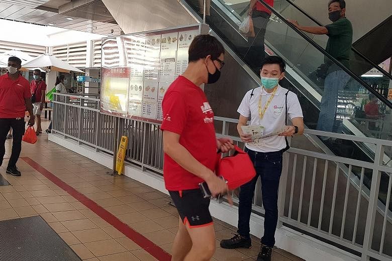 Mr Darren Ang, seen here giving out pamphlets to members of the public, said of his efforts as an SG Clean ambassador: "I don't see it as work - I see it as a very important mission." PHOTO: NATIONAL ENVIRONMENT AGENCY