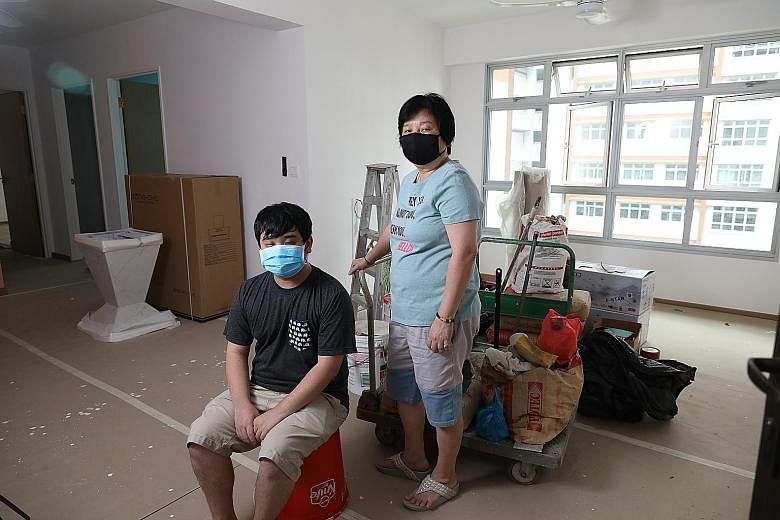 Madam Susie Koh and her son Joshua Tan in their half-renovated four-room BTO flat in Sengkang. Home renovation works have been halted due to the circuit breaker measures.