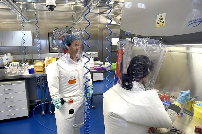 A 2017 file photo of researchers at a lab in the Wuhan Institute of Virology. The institute has dismissed claims that the novel coronavirus was synthesised at one of its laboratories or leaked from its facilities. Despite the scientific evidence to t