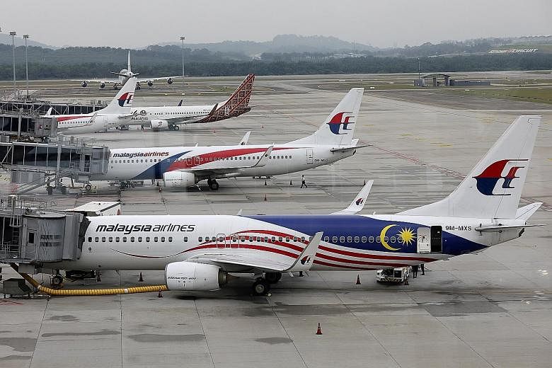 A merger between Malaysia Airlines and AirAsia was discussed even before the pandemic, said the Minister of International Trade and Industry. PHOTOS: REUTERS