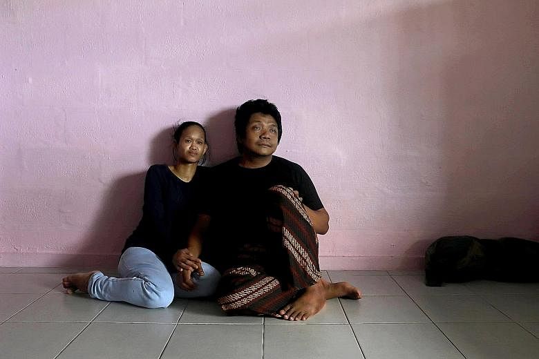 Sam (not his real name) and his wife in their two-room rental flat in Ang Mo Kio.