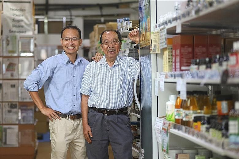 Nature's Glory founder Peter Lim, 77, with his son Christopher, 47, at their organic food shop in Tan Boon Liat Building. The firm plans to move into organic farming and start selling its products overseas. The elder Mr Lim quit his job as a business
