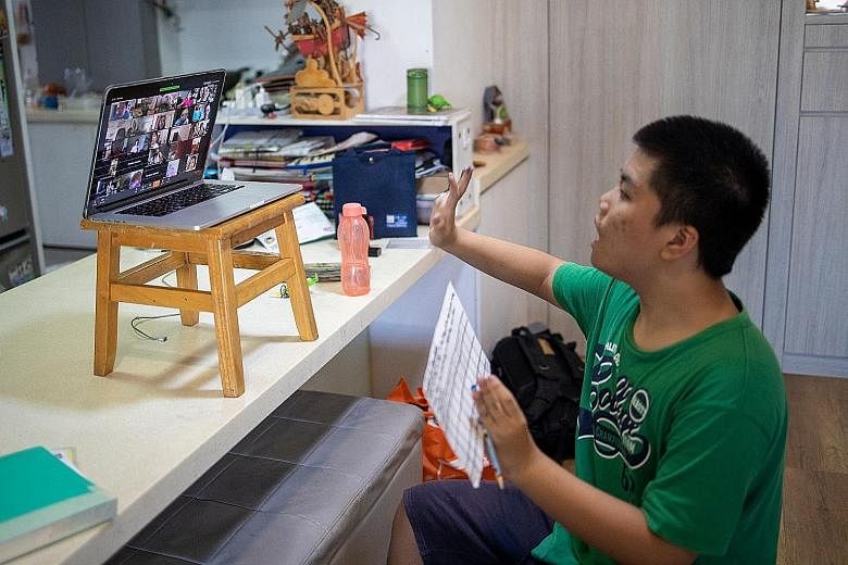 Left: Lee Jun Le, 13, taking part in Superhero Me's dance video conferencing session with other children, both with and without special needs.Below: Pathlight School pupil Maximilian So, 11, following moves shown in a video during a physical educatio