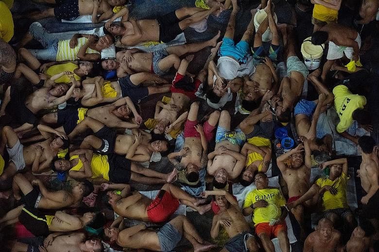 Prison inmates lying down to sleep last month in the crowded courtyard of the Quezon City Jail, north of Manila, where a Covid-19 outbreak has been detected. The Bureau of Jail Management and Penology has noted that "jail decongestion at this point i