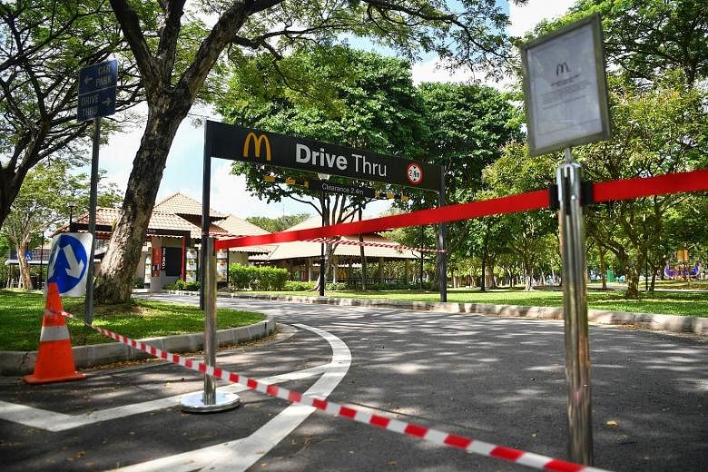The drive-through at McDonald's in West Coast Park (left) and the McDonald's outlet at White Sands mall (above) in Pasir Ris were among the more than 130 outlets here that shuttered yesterday. Seven employees have tested positive for Covid-19 in the 