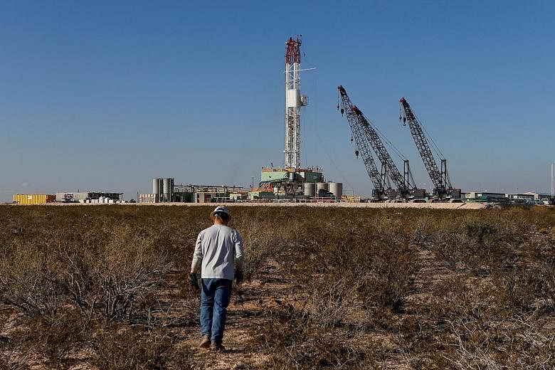 An oil drilling rig in Loving County, Texas, last year. The oil price collapse is reverberating across the industry, with crude explorers shutting down 13 per cent of the American drilling fleet last week.