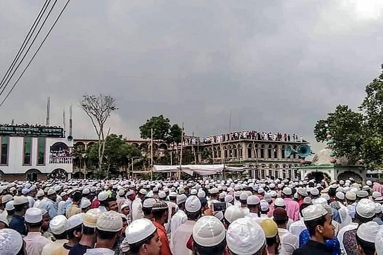 Muslim devotees attending the funeral of popular cleric Maulana Jubayer Ahmed Ansari in Brahmanbaria district, Bangladesh, last Saturday, during a government-imposed nationwide lockdown to halt the spread of Covid-19. The massive gathering has raised
