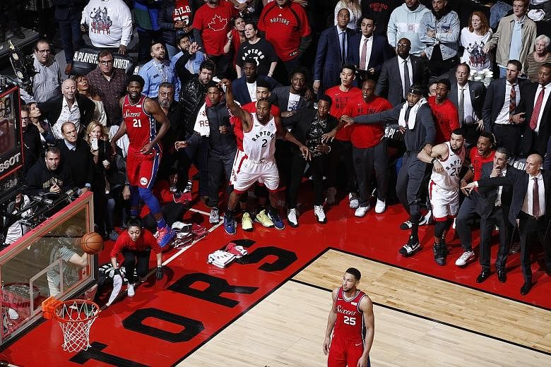 Left: Kawhi Leonard (No. 2), then of the Toronto Raptors, watching his game-winning buzzer-beater shot go into the net against the Philadelphia 76ers in Game 7 of last year's Eastern Conference semi-finals. Above: LA Lakers' Derek Fisher (front) and 