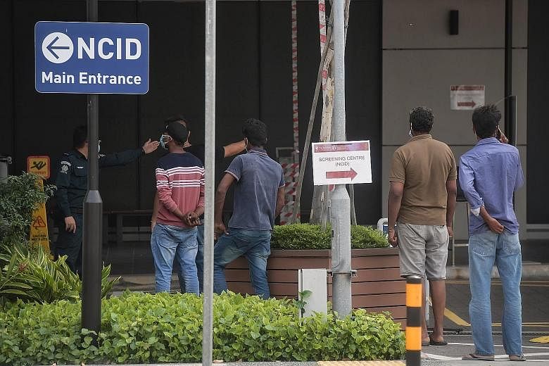 Foreign workers at the National Centre for Infectious Diseases last week. In densely populated communities like in the dormitories, each infected person could potentially infect as many as five to 10 others.