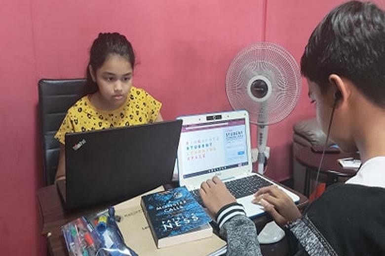 Siblings doing home-based learning at home. Their father, Mr Saravanan, said the emotional health of children could be a concern during the circuit breaker period. Brothers Gadiel (at left) and Rayhan playing a board game with their father Tengku Raz