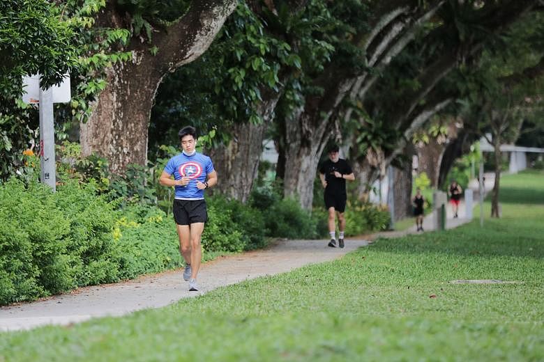 Left: Joggers practising social distancing on a walkway along Ang Mo Kio Avenue 1 yesterday, a day after stricter measures were announced. While exercising outdoors is still allowed, it is not encouraged, says SportSG. Those who insist on doing so mu