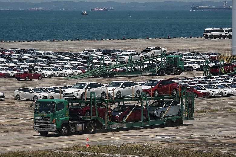 Rows of cars in Tanjong Pagar Terminal on Monday. A manager at a listed motor firm said: "Shipments are still coming in. Stock will pile up, and storage space is becoming a big issue."