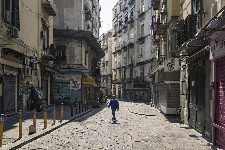 An empty market street in Naples, Italy, on April 12. The global economy is more likely to see a longer, U-shaped recovery after being pummelled into recession by the coronavirus pandemic, according to Reuters polls of economists from around the worl