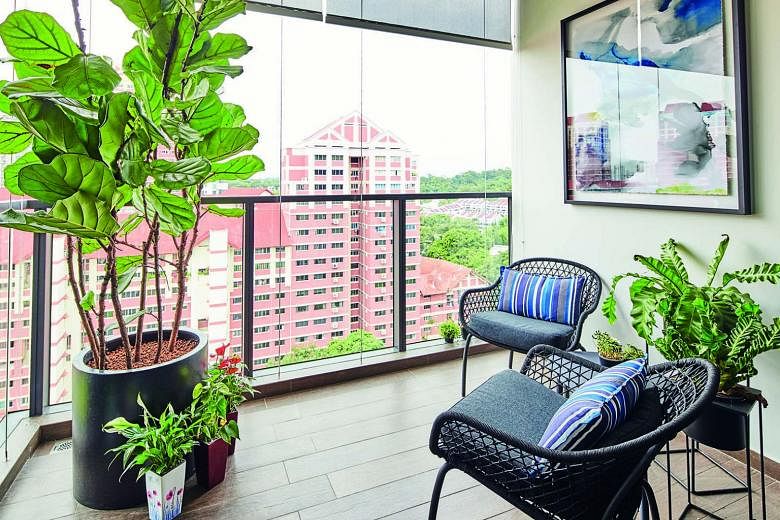 Simple furniture and plants bring the outdoors into the balcony, which also offers views of greenery in the Upper Thomson area.