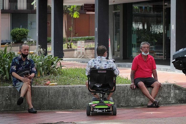 (Left) An elderly man exercising at Tampines Central Park on Wednesday. Social workers are reaching out to seniors such as these men, seen in public areas in Bukit Merah Central (above) and Jalan Sultan (below) over the past few days. ST PHOTOS: JASO
