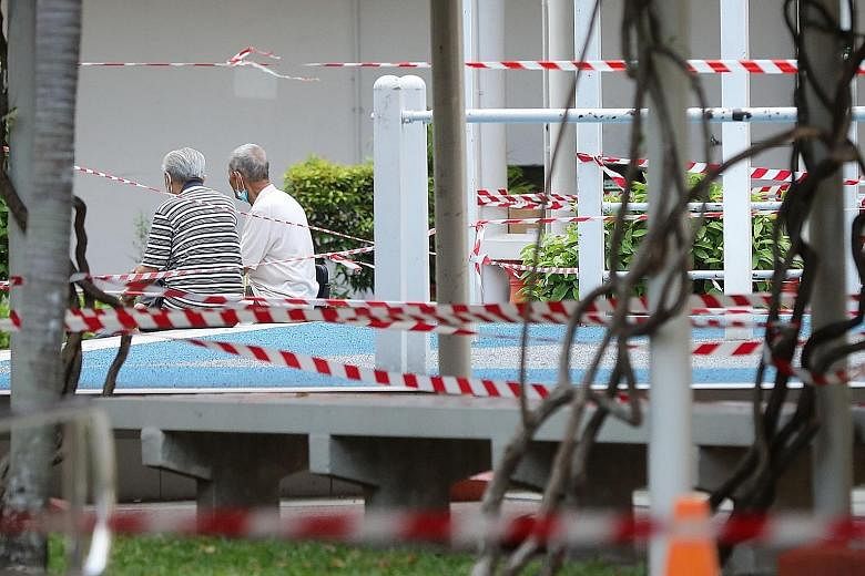 (Left) An elderly man exercising at Tampines Central Park on Wednesday. Social workers are reaching out to seniors such as these men, seen in public areas in Bukit Merah Central (above) and Jalan Sultan (below) over the past few days. ST PHOTOS: JASO