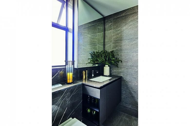 A wall-hung cabinet and vanity top create a cantilevered effect in the bathroom.