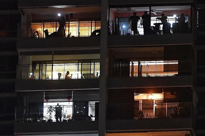 A car parked along Tampines Street 86 for its occupants to join in the islandwide singalong yesterday evening. Residents from Tampines GreenForest singing along to Home and flashing lights from their cellphones at 7.55pm yesterday. A resident at SkyV