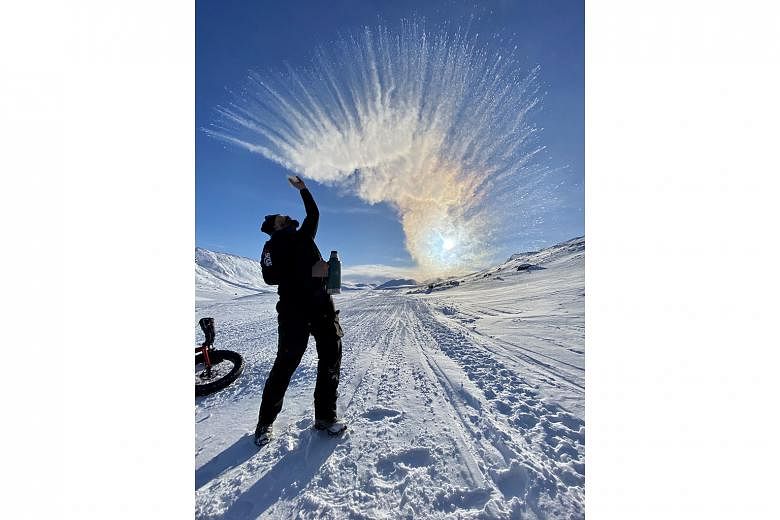 A team member throws hot water in the air to show how fast it turns to ice vapour.