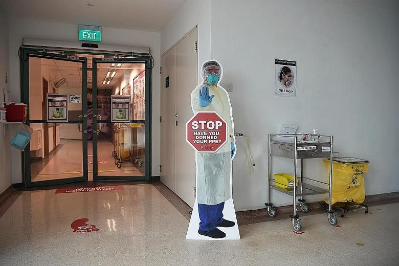 A nurse preparing to don her personal protective gear. Tan Tock Seng Hospital is one of the hospitals that have had to cope with the spike in infection cases in Singapore. ST PHOTO: KUA CHEE SIONG Exhaust fans installed at the windows in a Covid-19 w