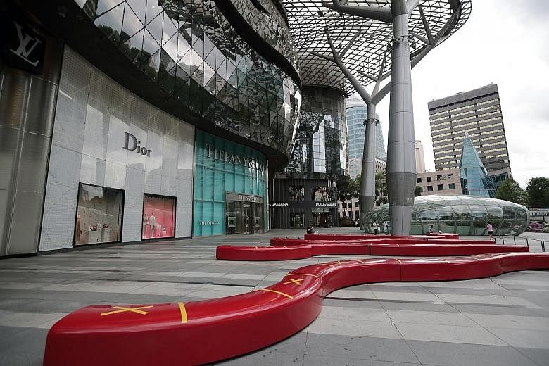 The area outside Ion Orchard (left) almost deserted on April 7 and the Prada store at Paragon closed on April 16 after circuit breaker measures took effect in Singapore early this month. City Developments Limited said it would enhance its rental reli