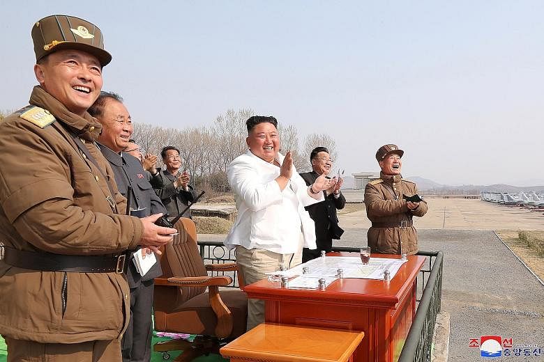 An April 12 photo showing North Korean leader Kim Jong Un applauding during a visit to a pursuit assault plane group in Pyongyang.