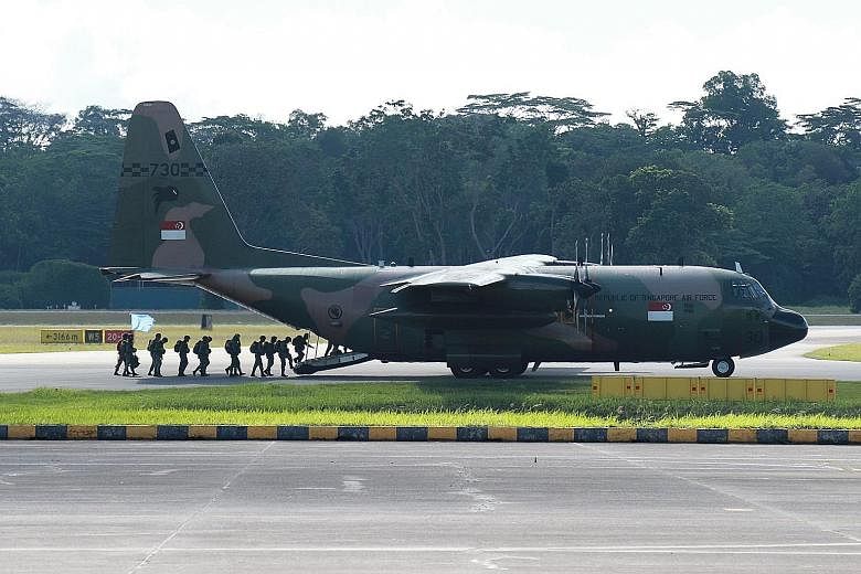 Regular commandos boarding the RSAF C-130 for a trial jump before static line parachute training resumed on Tuesday.