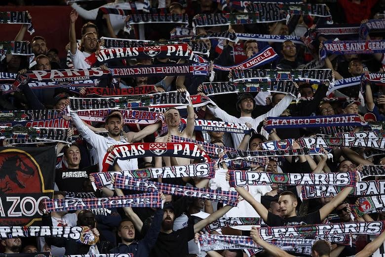 Paris Saint-Germain fans at the Parc des Princes in October. PSG are seeking alternative venues to host Champions League games should football not be able to resume at all in France this season.