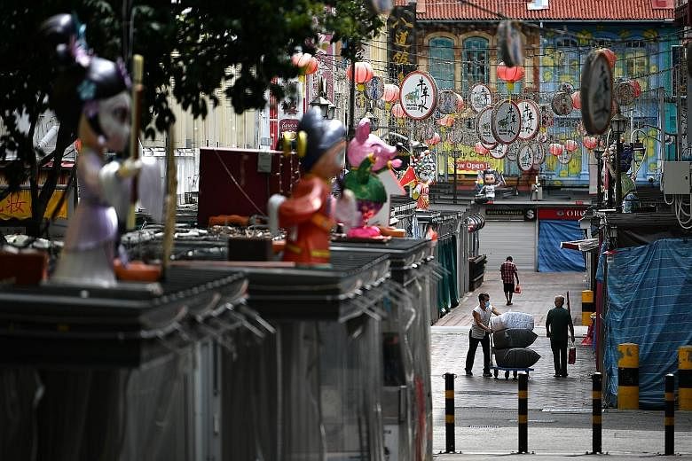 An almost deserted Trengganu Street in Chinatown yesterday. The tourism industry has been among the hardest hit by the coronavirus outbreak, with travel now at a halt and attractions and entertainment venues forced to close during the circuit breaker