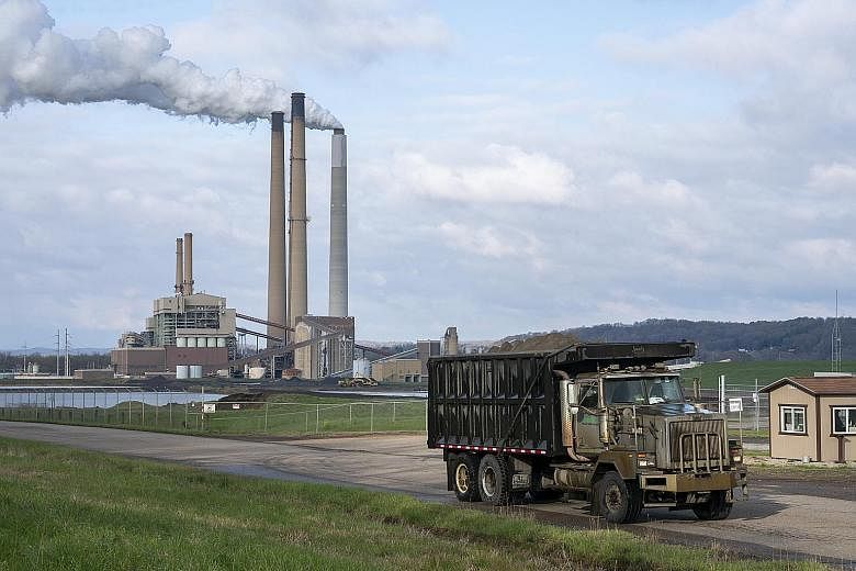 A truck carting coal ash near the Conesville Power Plant in Ohio, the United States. The International Energy Agency warns that if nations try to boost their economies after the lockdowns by subsidising polluting industries like coal, greenhouse gas 