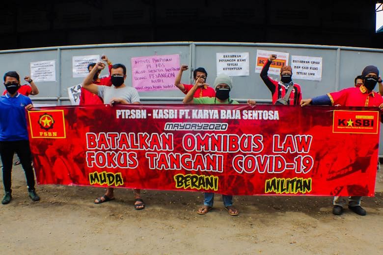 Workers taking part in a protest in Tangerang, Banten, on the outskirts of the Indonesian capital Jakarta, yesterday to call on lawmakers to drop “omnibus law” discussions to simplify dozens of existing laws relating to businesses, and focus on handling t