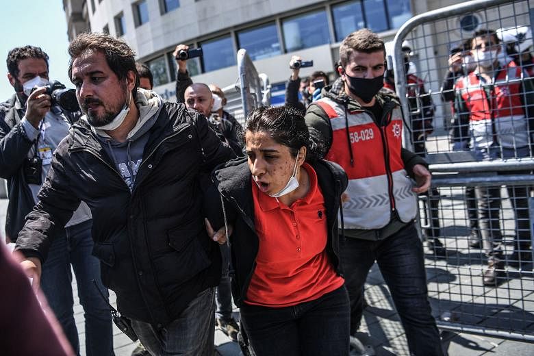 Above: Turkish police detaining a protester who wanted to march to Taksim Square for a May Day rally in Istanbul, amid a lockdown to curb the spread of the coronavirus. 