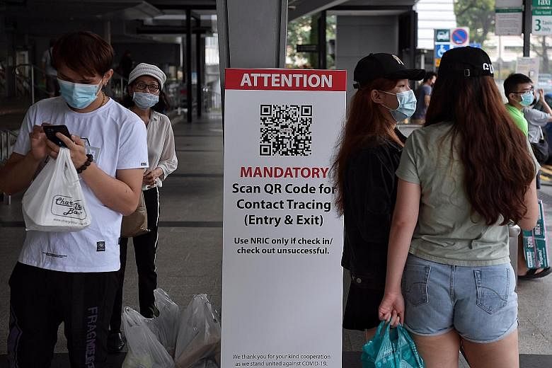 A QR code scanning station outside Nex mall in Serangoon Central. QR codes will be used at places with transient populations who are on the move. ST PHOTO: KUA CHEE SIONG
