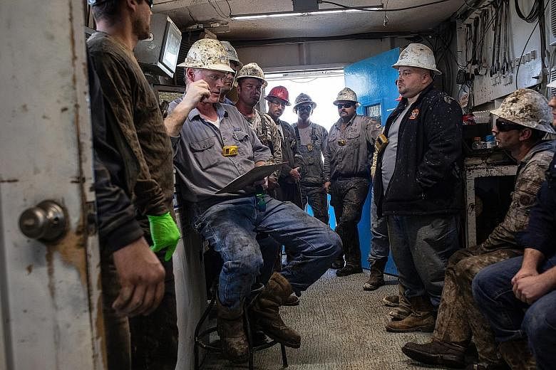 Workers at an oil rig last month in Texas, part of the US' Permian Basin, which recovered from a crash, only to face another one now. PHOTO: NYTIMES