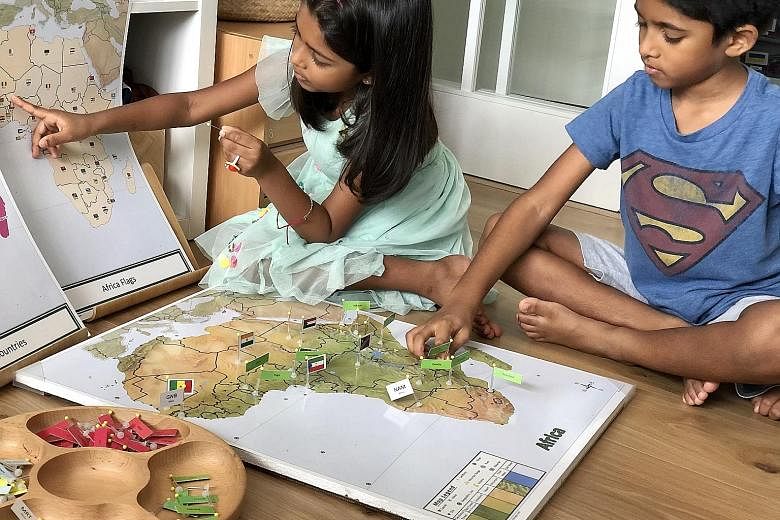 Six-year-old Alisha Sundar and her brother Aryan, eight, exploring different countries during their playtime at home. Recreation for them involves open-ended toys such as wooden blocks and art materials, as well as audio stories for children.