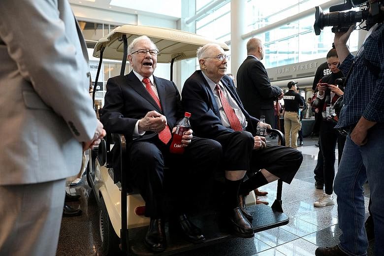 Berkshire Hathaway chairman Warren Buffett (left) and vice-chairman Charlie Munger at last year's annual Berkshire shareholder shopping day in Omaha, Nebraska. This year's meeting was devoid of such events.