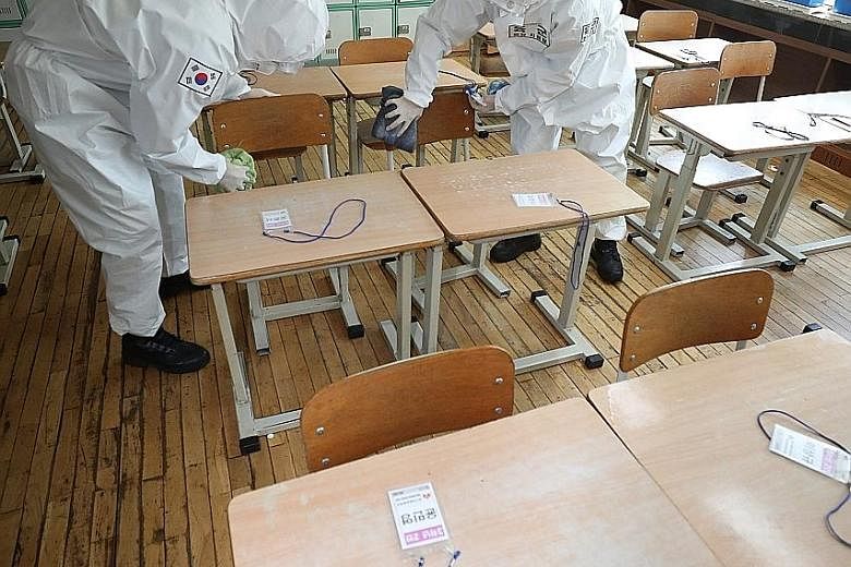 Army personnel disinfecting a classroom at an elementary school in Daegu, South Korea, last Friday. High school seniors will be the first to return to school on May 13, while the rest will follow in phases as schools reopen.