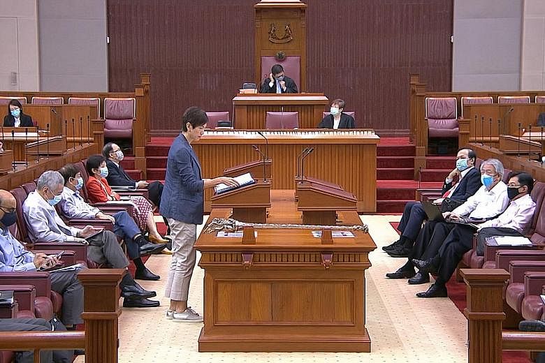Manpower Minister Josephine Teo speaking yesterday in Parliament, where all MPs donned face masks for the first time. They removed them only when speaking so that they could be heard clearly. PHOTO: GOV.SG