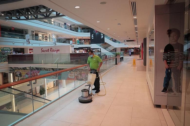 A cleaner at work in Plaza Singapura mall yesterday as shops and businesses remain shuttered for the extended circuit breaker period that ends on June 1. While it was a difficult decision to implement and extend the circuit breaker as businesses and 