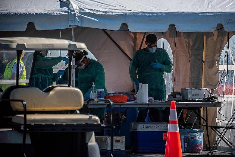 A Covid-19 drive-in testing site in Salisbury in America's Maryland state. A US study suggests easing lockdowns by the end of June may save 18 million jobs in the US but add over 200,000 virus deaths. PHOTO: AGENCE FRANCE-PRESSE