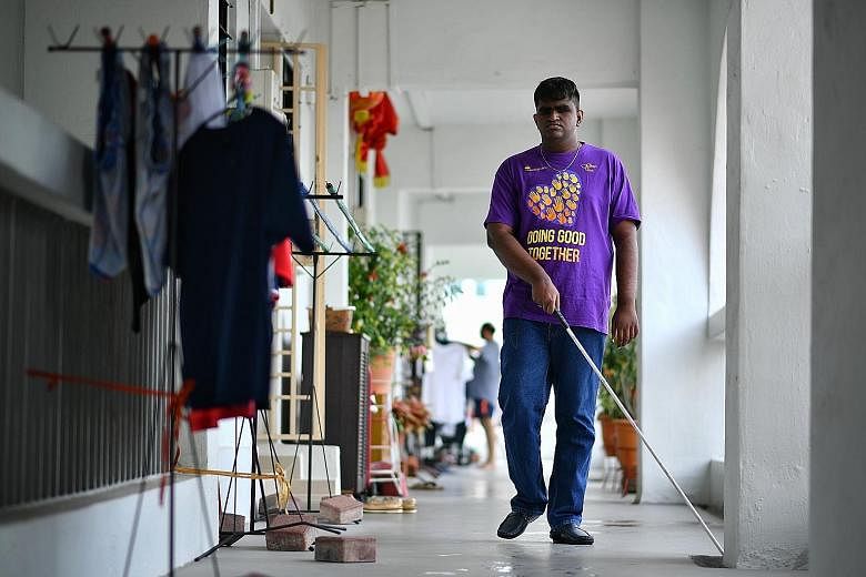 Mr John Danesh Krishnan, 21, who is blind, outside his home in Jurong. He had eye cancer and lost his sight at the age of two. He attended the School for the Visually Impaired, now known as the Lighthouse School, where he learnt Braille. It was also 