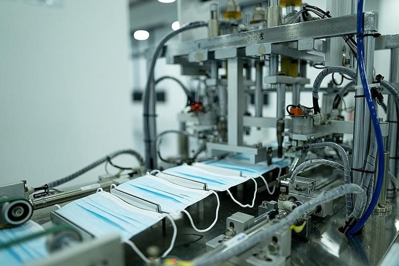 Surgical masks being manufactured on a production line run by ST Engineering. PHOTO: MINISTRY OF TRADE AND INDUSTRY