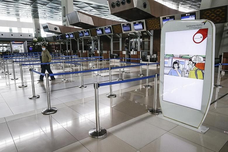 Empty check-in counters at Soekarno-Hatta International Airport in Tangerang, Indonesia, last month. Jakarta is still under a partial lockdown, which was recently extended to May 22.