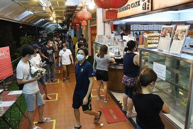 The queue at The Pine Garden bakery in Ang Mo Kio on April 22, following the announcement that tighter circuit breaker measures would kick in on 11.59pm that day. Like all other food outlets selling cakes and confectionery, it can resume selling cake