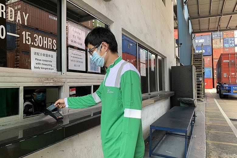 A driver using the DBS Logistics Purchasing Card to settle payment at one of Yang Kee Logistics' container depots in Tuas.