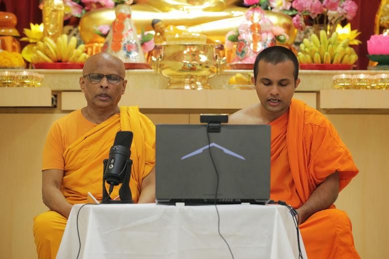 Singapore Buddhist Mission's Venerable K. Dhammika Maha Thera (left) and Venerable T. Chandima Thera conducting Pali chanting yesterday.