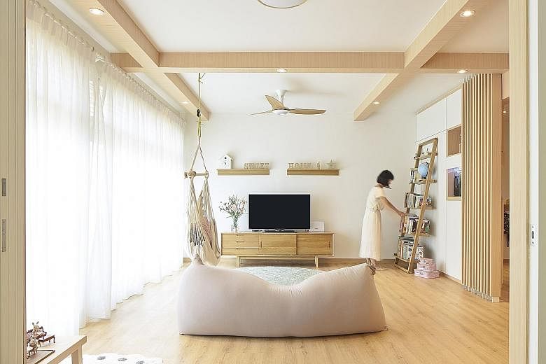 Designed by Chalk Architects, this five-room Housing Board flat has a Japanese-style concept, where its living room (above) adjoins a tatami room. 